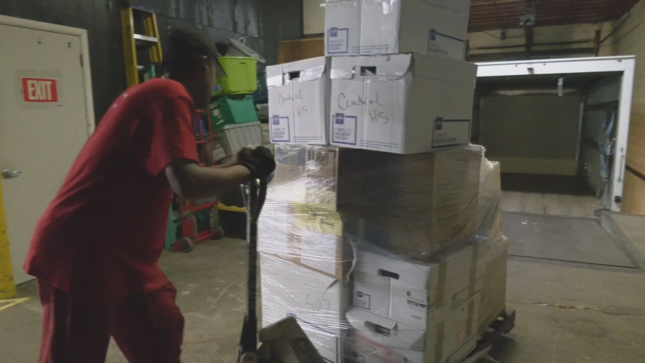 Volunteers for Louisville-based SOS pack medical supplies for JCPS students